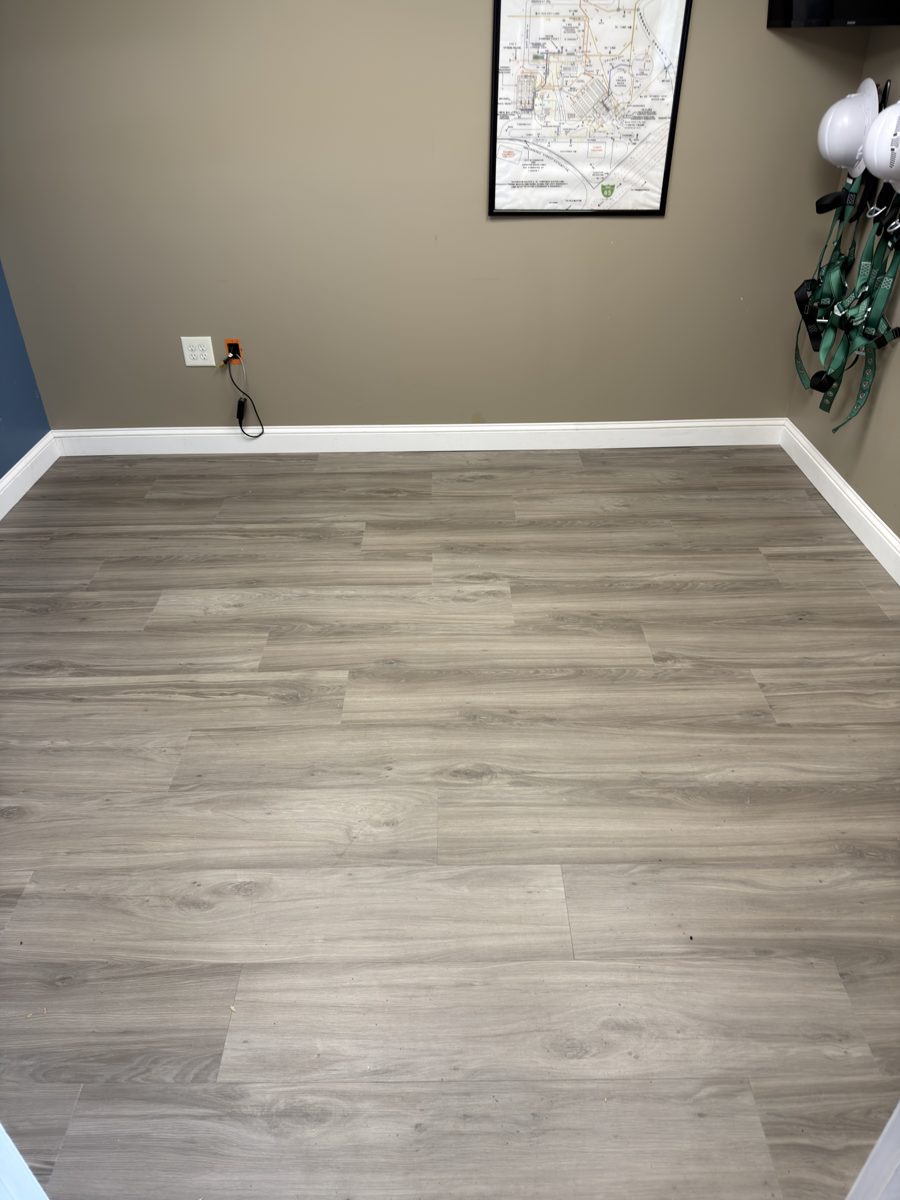 Small office with finished gray LVP flooring and white trim